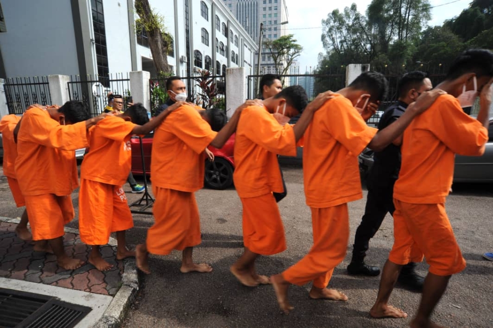 The seven suspects, aged between 14 and 17, were brought by the police to the Magistrate's Court in Johor Baru to be remanded for two days starting today, August 15, 2023. — Picture by Ben Tan