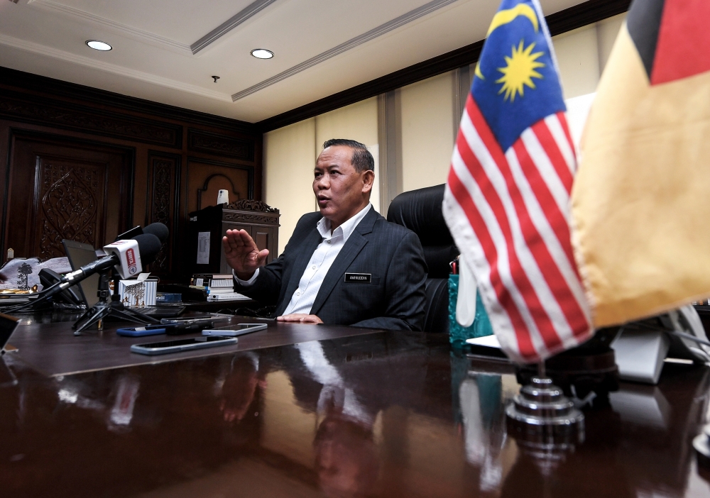 Negeri Sembilan Menteri Besar Datuk Seri Aminuddin Harun speaks to the media after starting his official duties as the menteri besar at Wisma Negeri, Seremban, August 15, 2023. — Bernama pic 