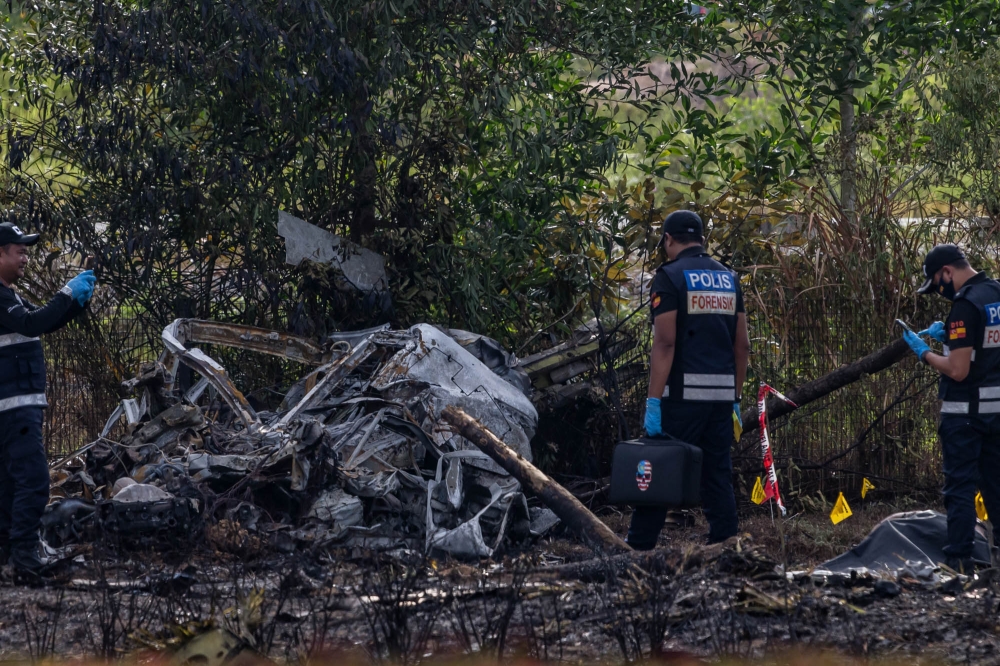 Forensics officers pictured at the plane crash site in Elmina, Shah Alam, August 17, 2023. — Picture by Firdaus Latif