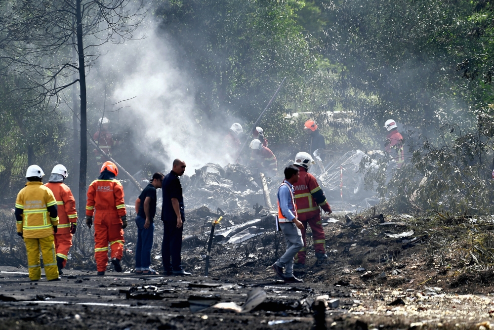 Fire and Rescue Department personnel putting out the fire at the site of the crash in Bandar Elmina, Shah Alam, August 17, 2023. — Bernama pic