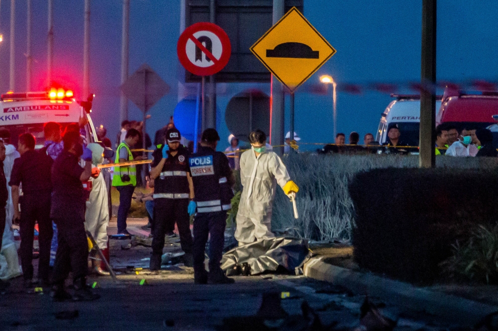 Forensics officers pictured at the site of the plane crash in Elmina, Shah Alam, August 17, 2023. — Picture by Firdaus Latif