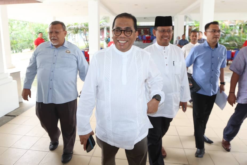 Johor Pakatan Harapan deputy chairman Aminolhuda Hassan (left) and Johor Umno chairman Datuk Seri Mohamed Khaled Nordin (2nd left) leave a closed-door meeting at the state Umno liaison office in Johor Baru on August 18, 2023. — Picture by Ben Tan
