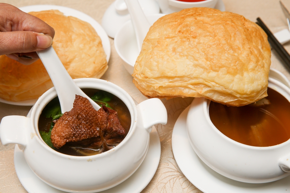 Soups are a specialty of Ah Soon Kor and are celebrated with a modern puff pastry lid that you can dip into the Double Boiled Duck and Tangerine Peel Health Soup (left) and Foie Gras in Supreme Soup (right).