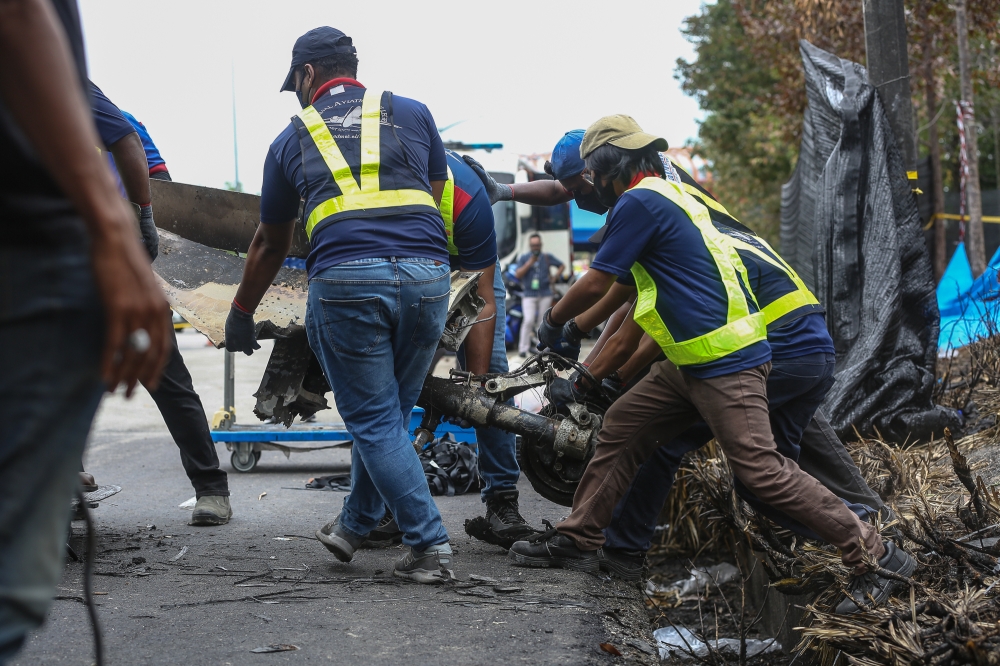 A team from Admal Aviation Collage collects the wreckage of the aircraft at the site of the Elmina plane crash in Shah Alam on August 21, 2023. — Picture by Yusof Mat Isa