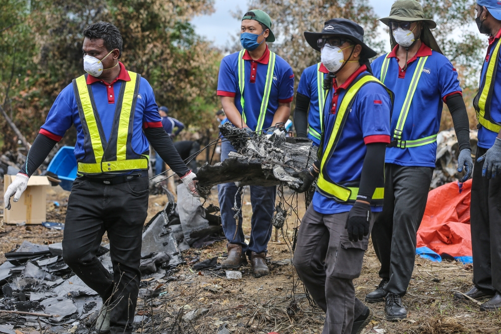 Work on removing pieces of the plane in progress. — Picture by Yusof Mat Isa