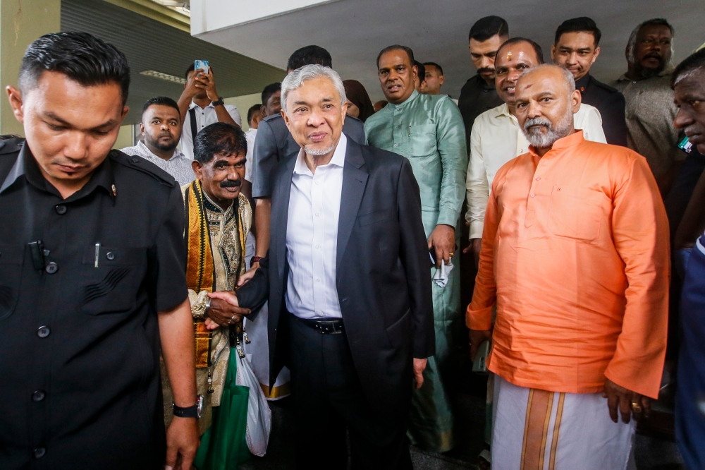 Deputy Prime Minister Datuk Seri Ahmad Zahid Hamidi (centre) asked the High Court in Kuala Lumpur if his trial on Wednesday could be heard on another day instead, as he will have to attend Cabinet’s weekly meeting on that day. — Picture by Hari Anggara.