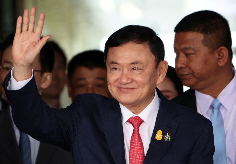 Former Thai prime minister Thaksin Shinawatra, who is expected to be arrested upon his return as he ends almost two decades of self-imposed exile, waves at Don Mueang airport in Bangkok, Thailand August 22, 2023. ― Reuters pic