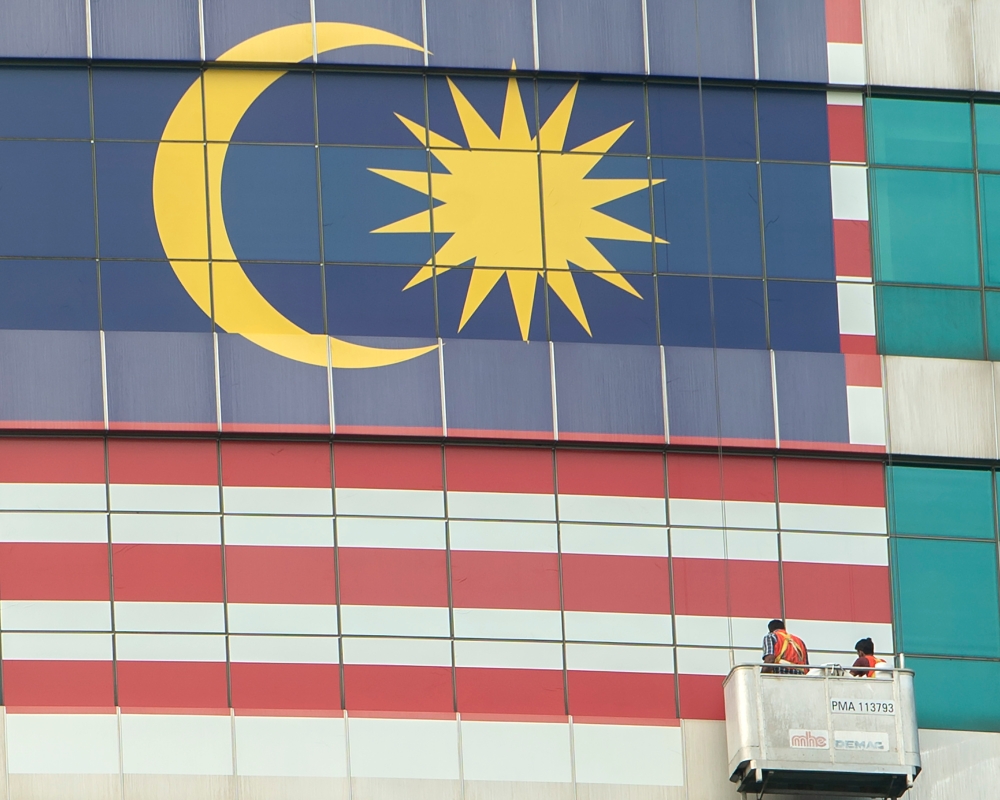 The Jalur Gemilang is seen on a building in Putrajaya in conjunction with Malaysia 66th National Day celebration, August 23 2023. — Picture by Shafwan Zaidon