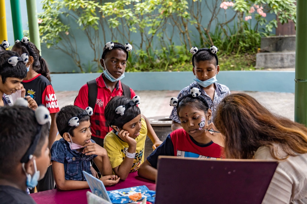 A girl gets her face painted during the 17th birthday celebration of giant pandas Xing Xing and Liang Liang at the National Zoo in Kuala Lumpur August 23, 2023. — Picture by Firdaus Latif