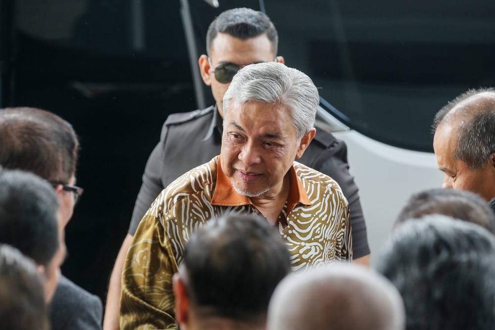 Deputy Prime Minister Datuk Seri Ahmad Zahid Hamidi (centre) arrives at the Kuala Lumpur High Court August 24, 2023. — Picture by Hari Anggara