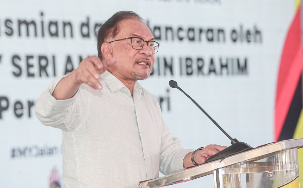 Prime Minister Datuk Seri Anwar Ibrahim speaks at the launch of he Works Ministry’s MyJalan Campaign in Gerik August 24, 2023. — Picture by Farhan Najib
