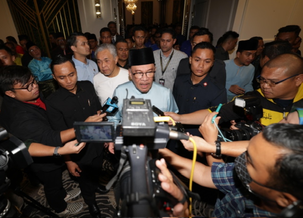 Prime Minister Datuk Seri Anwar Ibrahim speaks to reporters after attending a unity government programme at the Sunway Hotel Big Box in Iskandar Puteri, on August 25, 2023. — Picture by Ben Tan