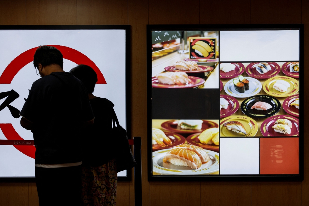 Customers queue in front of a sushi restaurant after Japan's release of treated radioactive water from the crippled Fukushima nuclear plant into the sea, in Hong Kong, China, August 25, 2023. — Reuters pic