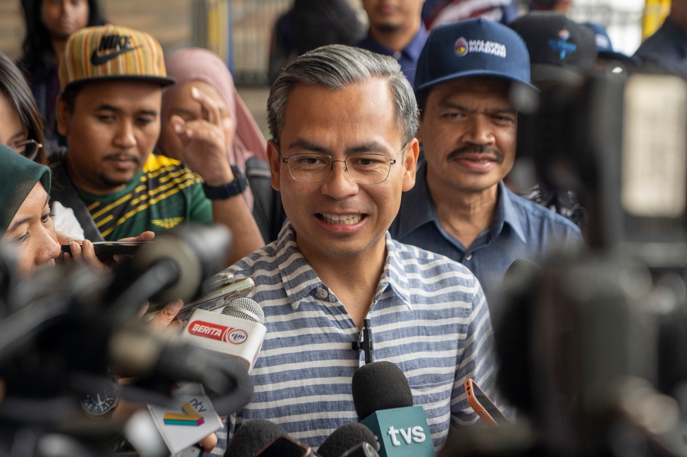 Communications and Digital Minister Fahmi Fadzil speaks to reporters after checking on preparations in conjunction with the 2023 National Day celebration at Dataran Putrajaya 26 August 2023. — Picture by Shafwan Zaidon