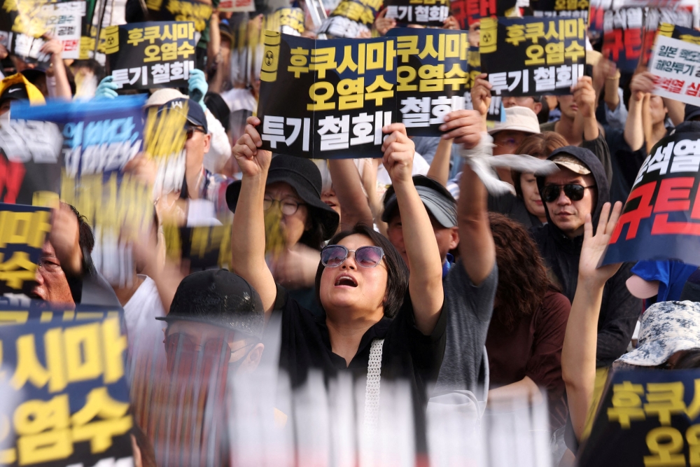 South Korean people chant slogans during a protest against Japan’s discharge of treated radioactive water from the wrecked Fukushima nuclear power plant into the Pacific Ocean, in Seoul, South Korea, August 26, 2023. ― Reuters pic