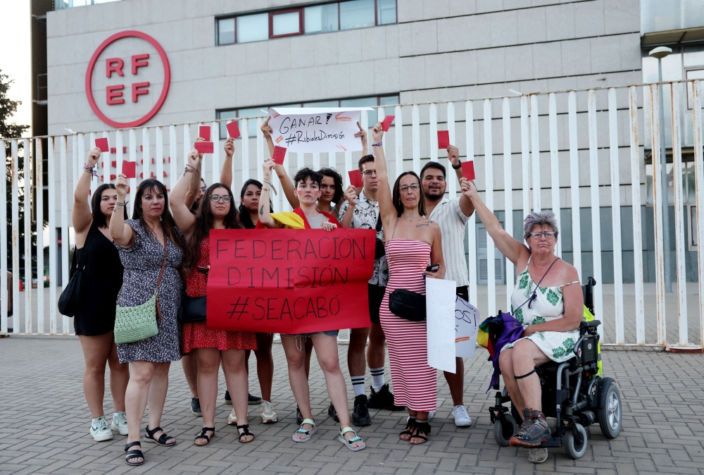 People hold banners as they protest against President of the Royal Spanish Football Federation Luis Rubiales at Las Rozas in Spain on August 25, 2023. ― Reuters pic