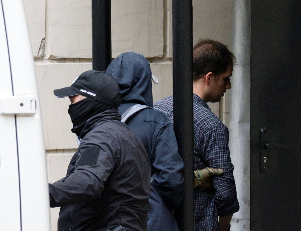 Wall Street Journal reporter Evan Gershkovich, who was arrested in March while on a reporting trip and accused of espionage, is escorted into a court building before a hearing on extending his pre-trial detention, in Moscow, Russia August 24, 2023. ― Reuters pic
