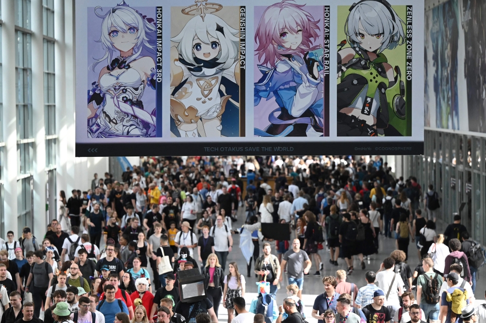 A photo shows visitors at the Gamescom video game fair in Cologne. — AFP pic