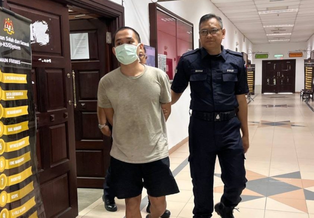 Milan Andrian exits the courtroom after his proceedings at Kuching Court Complex here today. — Borneo Post pic 