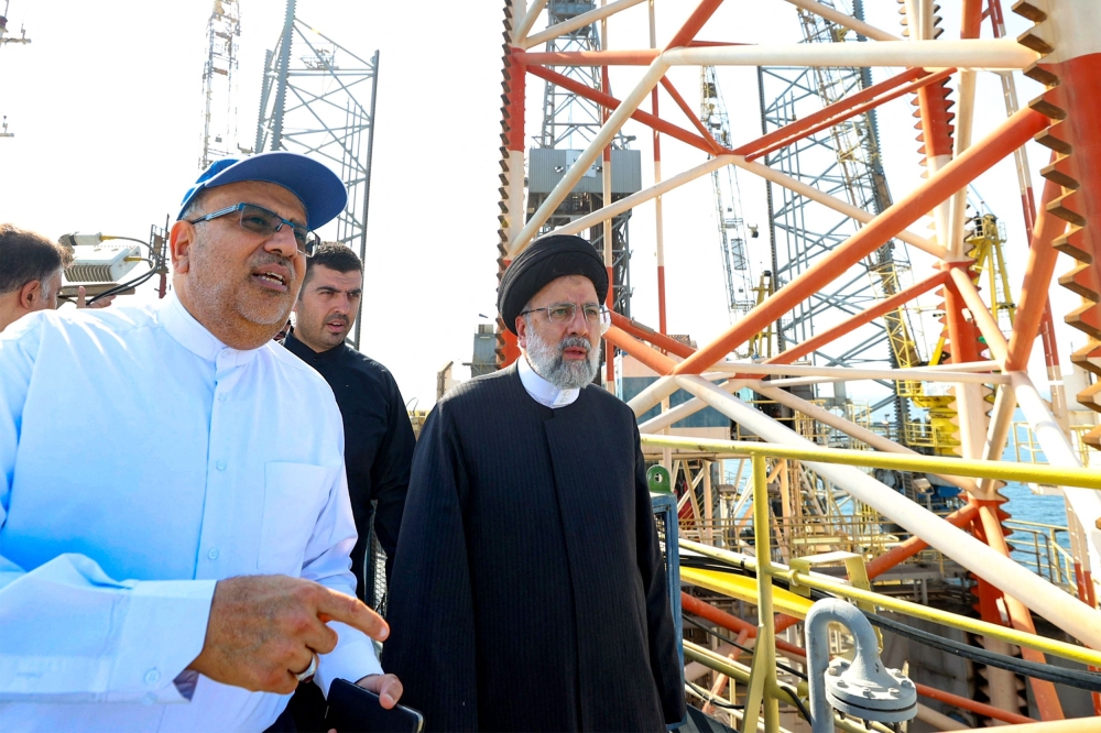 A handout picture provided by the Iranian presidency on August 29, 2023, shows Iranian president Ebrahim Raisi (centre) visiting Asaluyeh port in the southwestern Bushehr province for the inauguration of Phase 11 of the South Pars gas field. — Iranian Presidency handout pic via AFP 