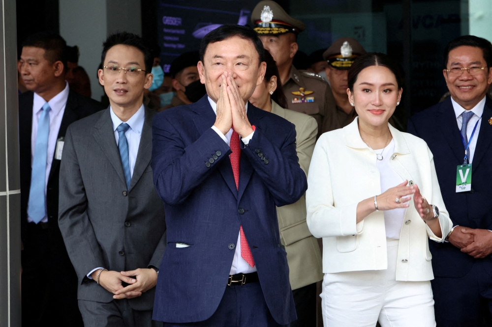 Former Thai PM Thaksin Shinawatra seen here with his son Panthongtae Shinawatra and daughter Paetongtarn Shinawatra at Don Mueang airport in Bangkok, Thailand August 22, 2023. ― Reuters pic
