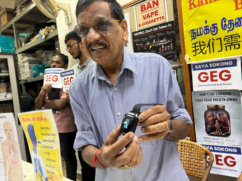 Subbarow showing a vape device in the form of a watch at the CAP office in George Town August 30, 2023. — Picture by Opalyn Mok