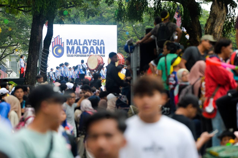 People gather to watch the Merdeka Day parade in Putrajaya August 31, 2023. ― Picture by Miera Zulyana