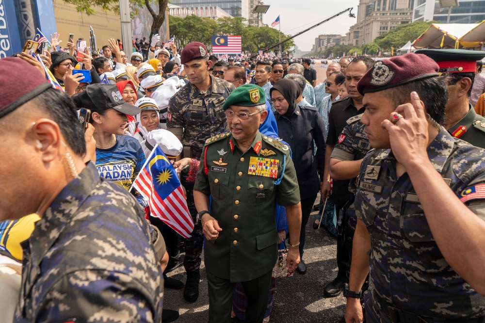 Yang di-Pertuan Agong Al-Sultan Abdullah Ri'ayatuddin Al-Mustafa Billah Shah greets the crowd during the Merdeka Day parade in Putrajaya August 31, 2023. ― Picture by Shafwan Zaidon