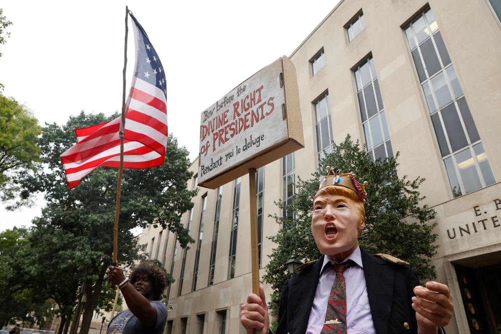 A supporter of former US President Donald Trump and an anti-Trump demonstrator protest outside the E. Barrett Prettyman United States Courthouse on the day of a hearing in the U.S. Justice Department's federal criminal case against former US  President Donald Trump at US District Court in Washington August 28, 2023. — Reuters pic