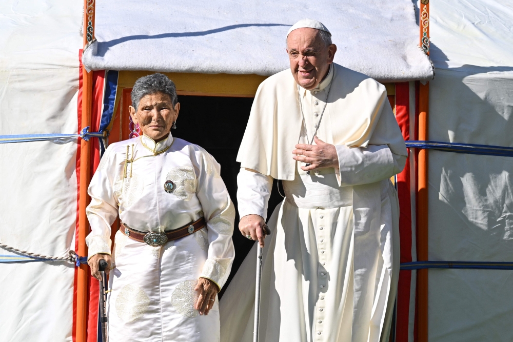 Pope Francis exits a yurt with Tsetsege (left), who some ten years ago had rescued a statuette of the Lady Mother of Heaven from a pile of garbage and later enthroned in the Saints Peter and Paul Cathedral, on the cathedral compounds where the pope is due to meet with bishops, priest, missionaries, consecrates persons and pastoral workers during his papal visit to Mongolia, in Ulaanbaatar on September 2, 2023. — AFP pic