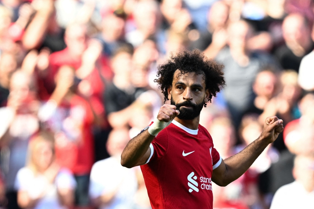 Liverpool's Egyptian striker #11 Mohamed Salah celebrates after scoring his team third goal during the English Premier League football match between Liverpool and Aston Villa at Anfield in Liverpool September 3, 2023. — AFP pic