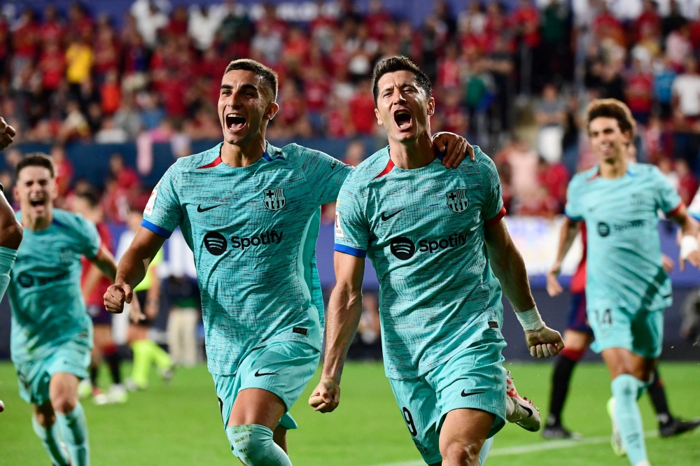 Barcelona's Spanish forward #07 Ferran Torres (L) celebrates Barcelona's Polish forward #09 Robert Lewandowski's goal scored from the penalty spot during the Spanish Liga football match between CA Osasuna and FC Barcelona at El Sadar stadium in Pamplona on September 3, 2023. — AFP pic