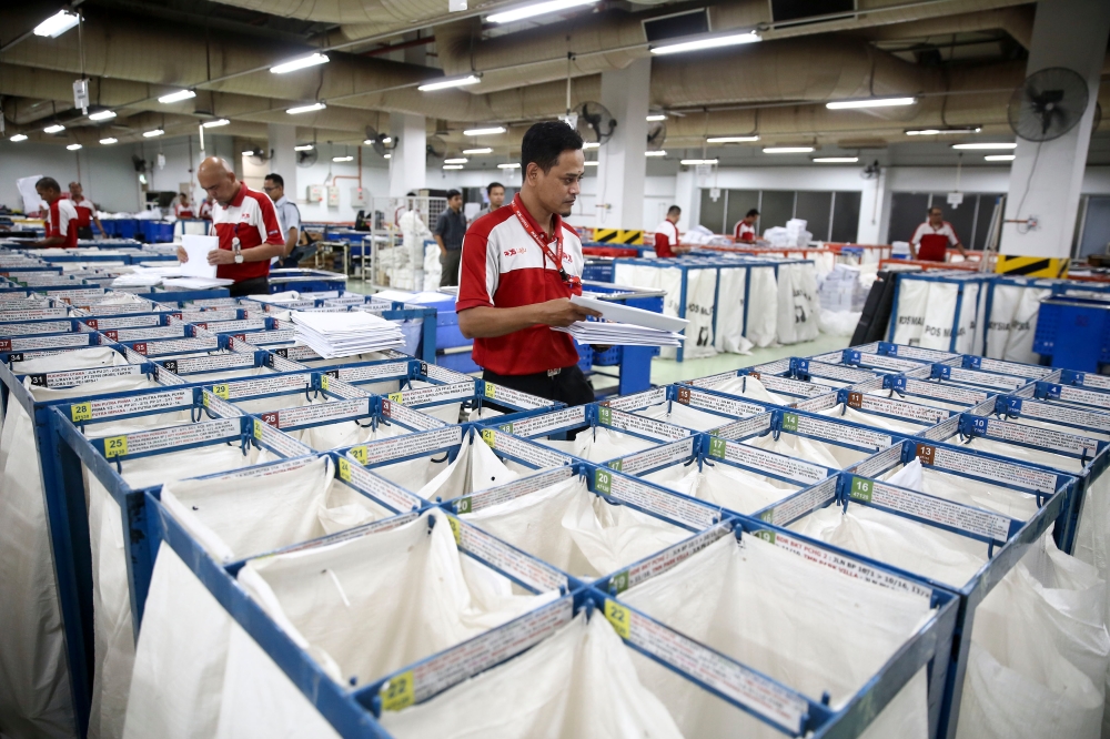 Pos Malaysia staff sorts mail for delivery at Pusat Mel Nasional in Shah Alam May 15, 2019. Pos Malaysia is actively enhancing its capacity to effectively manage the surge in demand for its services. — Picture by Yusof Mat Isa