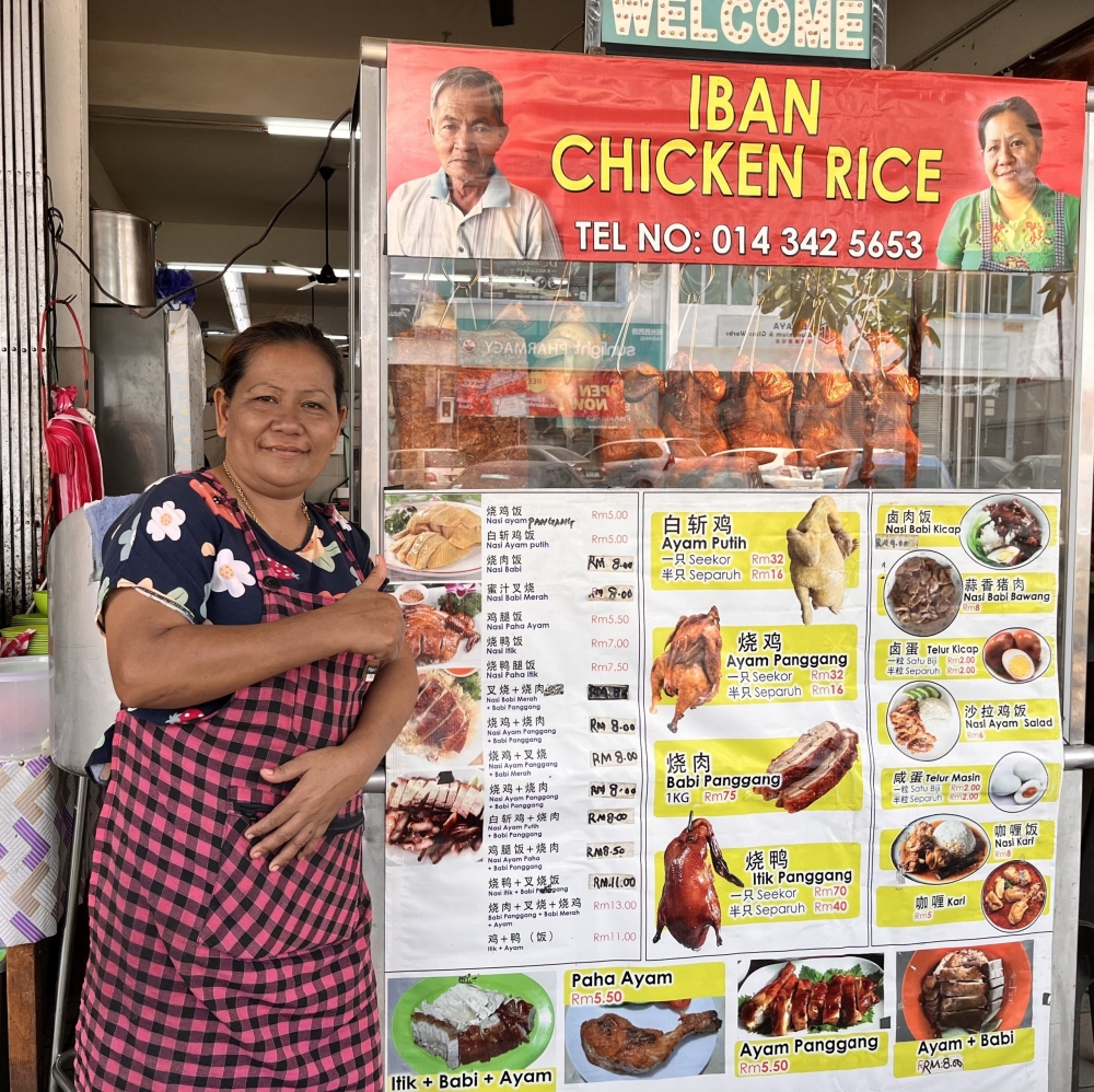 Sudih operates her ‘Iban Chicken Rice’ stall at an eatery in Sibu Jaya. ― Borneo Post pic