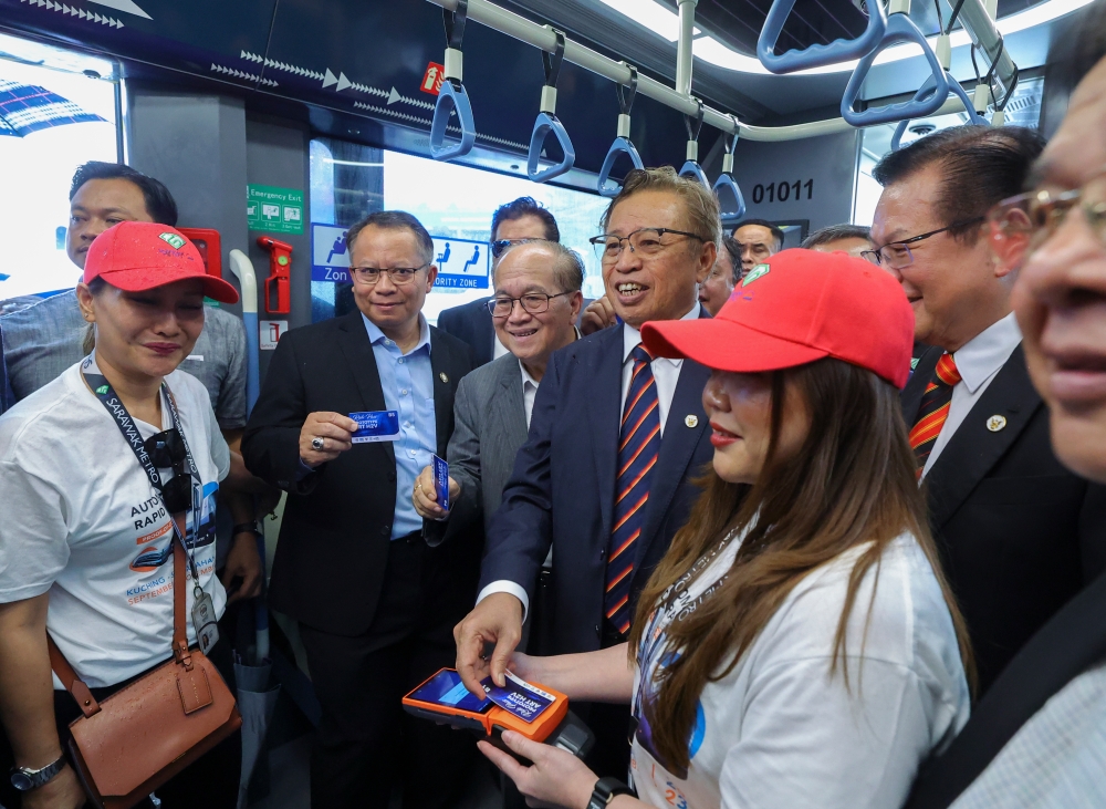 Sarawak Premier Tan Sri Abang Johari Tun Openg (centre) taking a ride on a prototype Autonomous Rapid Transit (ART) vehicle unit during a test drive session in Kuching, September 6, 2023. — Bernama pic