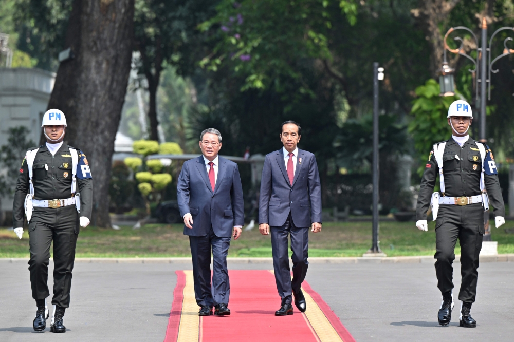 China's Premier Li Qiang (centre left) and Indonesia's President Joko Widodo (centre right) attend a welcome ceremony at the presidential palace in Jakarta September 8, 2023. — AFP pic