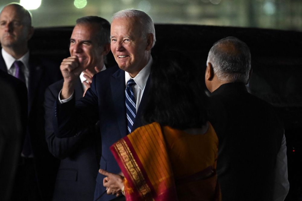 US President Joe Biden (centre) gestures upon his arrival at the airport on the eve of the two-day G20 summit in New Delhi September 8, 2023. — AFP pic