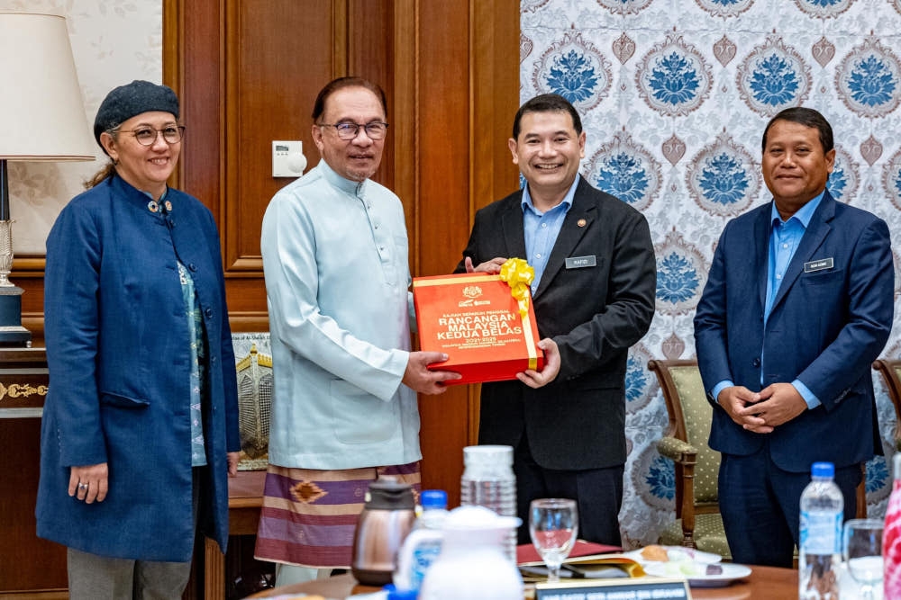 The document handover session marks the completion of the 12MP MTR document preparation prior to its tabling by the prime minister in Parliament on September 11, 2023, the Economy Ministry said in a Facebook post today. — Picture from Facebook/Anwar Ibrahim 
