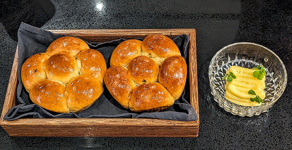 Milk buns glazed in duck fat, served with honey butter on the side. What a tease. – Pictures by Ethan Lau