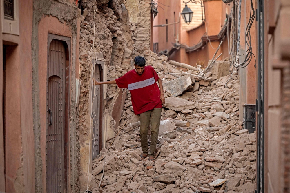 A resident navigates through the rubble following a 6.8-magnitude quake in Marrakesh on September 9, 2023. — AFP pic