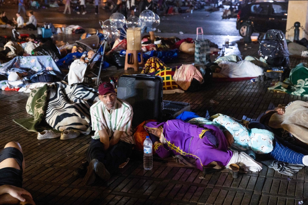 Residents take shelter outside at a square following an earthquake in Marrakesh on September 9, 2023. — AFP pic