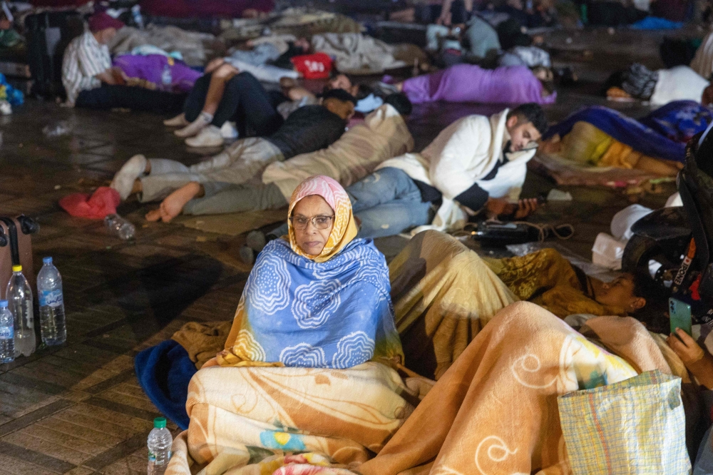 Residents take shelter outside at a square following an earthquake in Marrakesh on September 9, 2023. — AFP pic