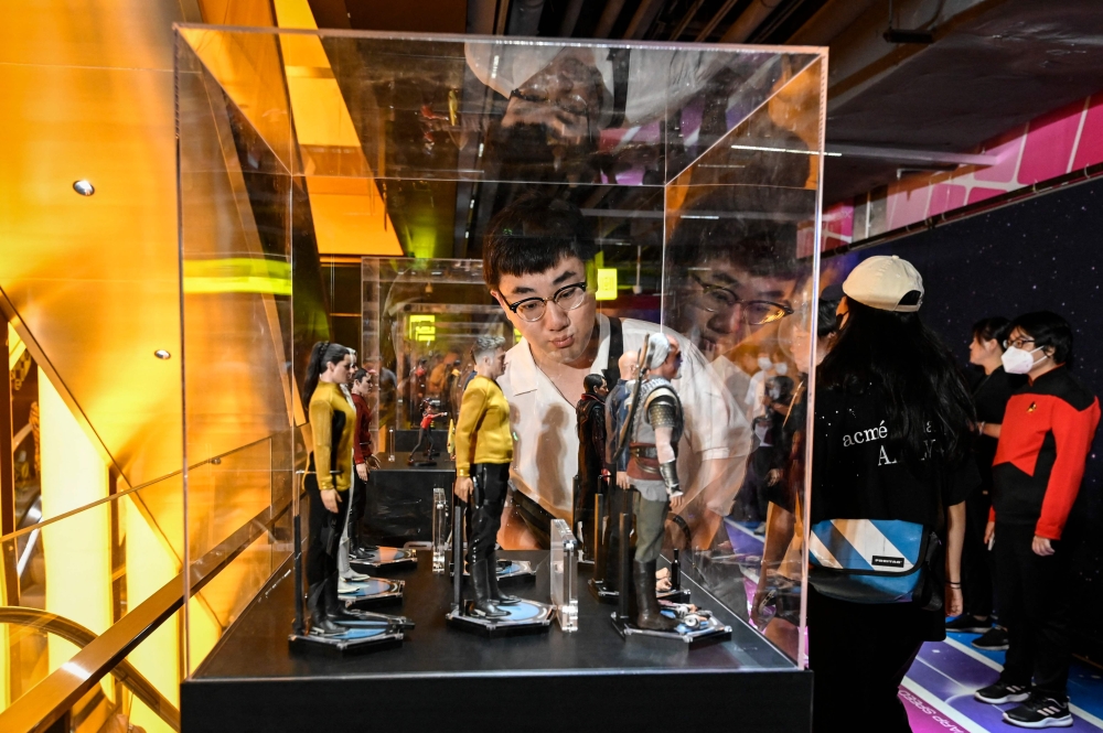A Star Trek fan looks at collectible items during mainland China’s first official fandom event for science-fiction adventure franchise Star Trek, at a shopping mall in Beijing on September 9, 2023. — AFP pic