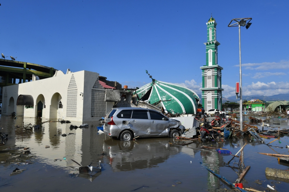 File photo of a collapsed mosque seen amid waters from a tsunami surge in Palu, Indonesia's Central Sulawesi on September 30, 2018, following the September 28 earthquake and tsunami. — file pic