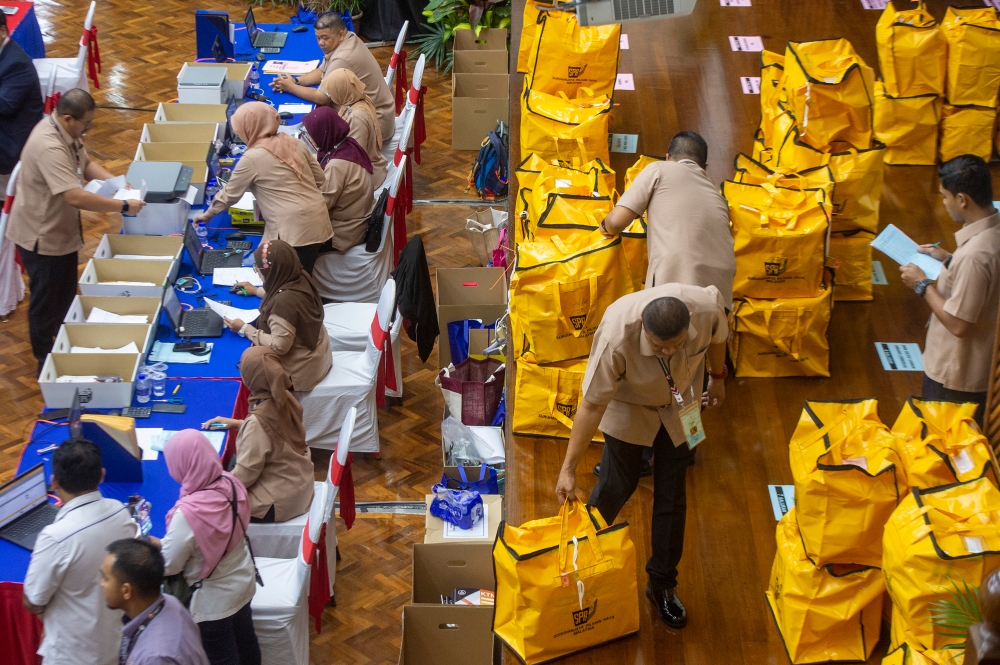 Election Commission (EC) personnel arrange ballot boxes at the vote counting centre during Pulai by-election at Dewan Jubli Intan Sultan Ibrahim in Johor Baru September 9, 2023. — Picture by Shafwan Zaidon