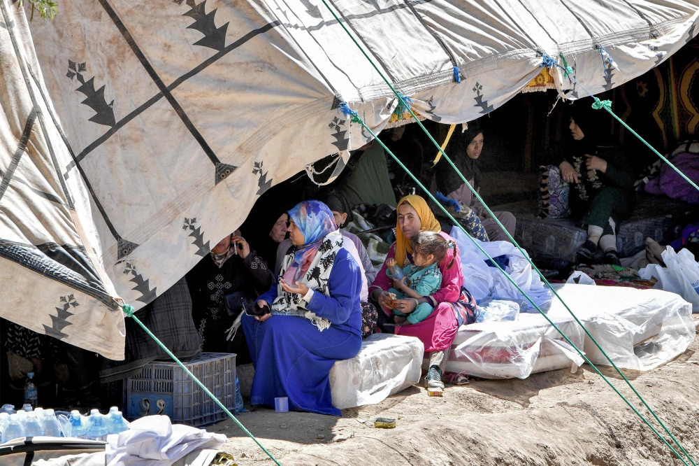 Survivors of the deadly 6.8-magnitude September 8 earthquake gather under a tent in the village of Tikht near Adassil in central Morocco on September 10, 2023. — AFP pic