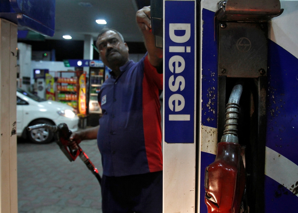 A worker switches on a fuel pump before filling a car with diesel at a fuel station in New Delhi September 13, 2012. — Reuters pic