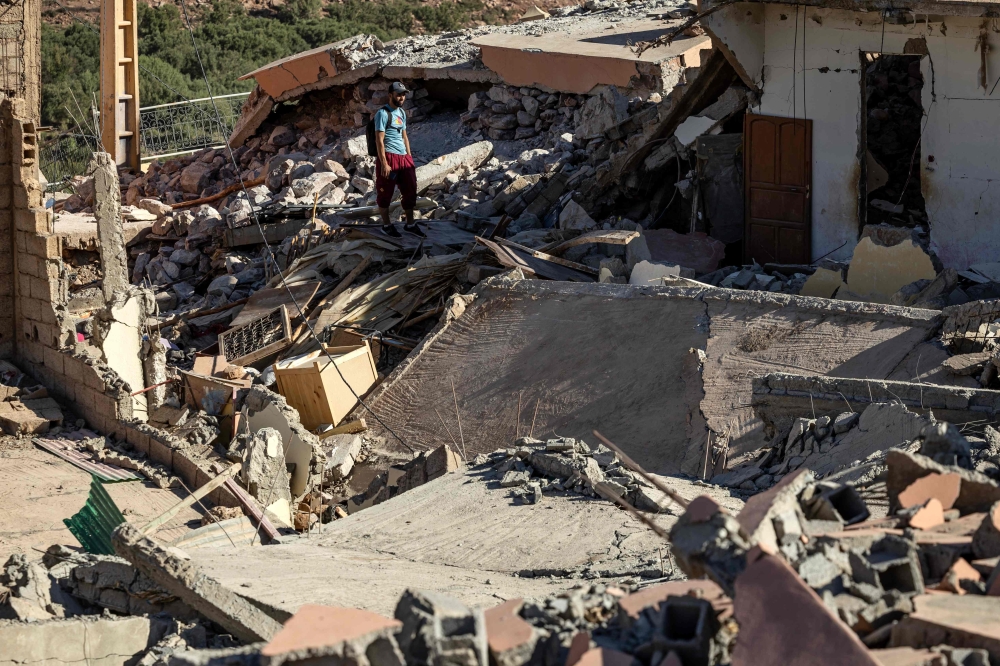 A man looks at the rubble of homes in the village of Talat N'Yacoub, south of Marrakech September 11, 2023. The quake killed at least 2,122 people, injured more than 2,400 others, and flattened entire villages. — AFP pic 