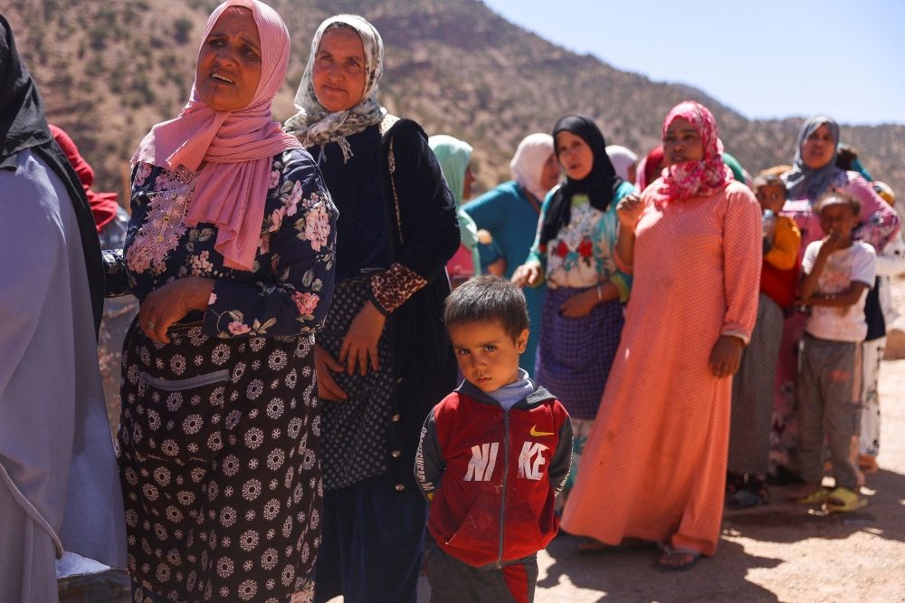 Women and children queue for aid, in the aftermath of a deadly earthquake, in Tinmel, Morocco, September 11, 2023. — Reuters pic
