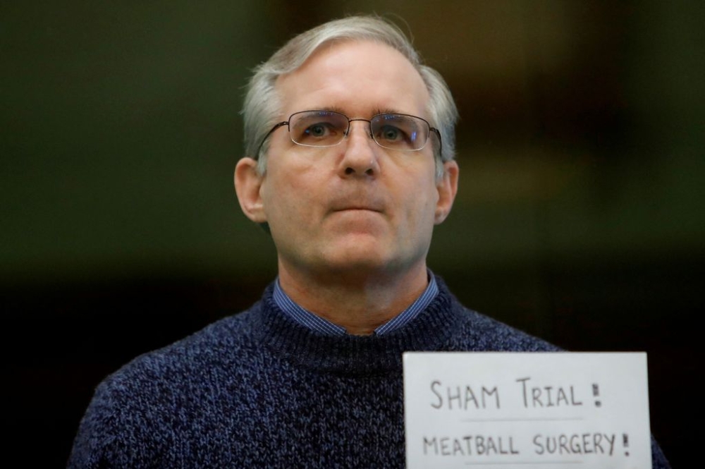 Former US Marine Paul Whelan, who was detained and accused of espionage, stands inside a defendants' cage during his verdict hearing in Moscow, Russia June 15, 2020. — Reuters pic
